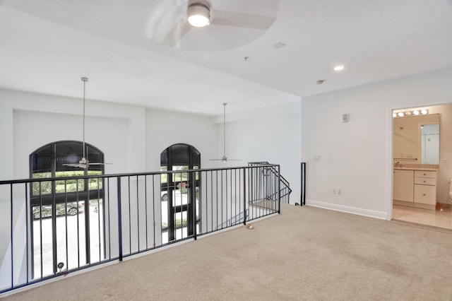 hallway with light carpet and a healthy amount of sunlight