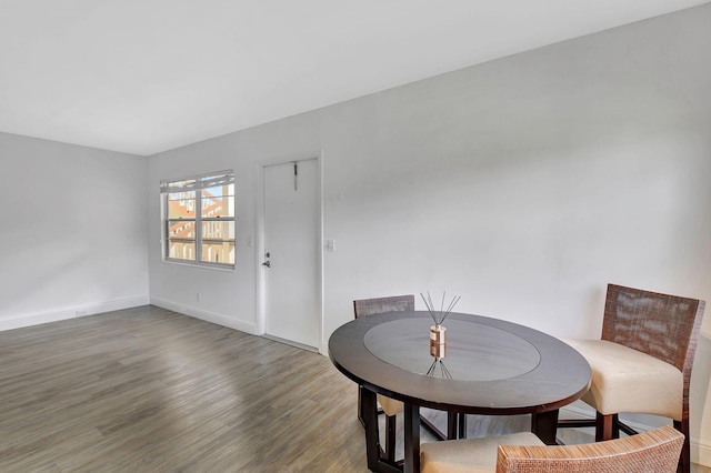 dining space with hardwood / wood-style flooring