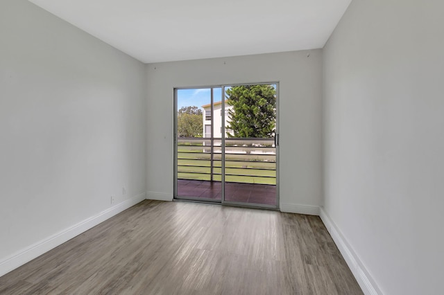 unfurnished room with hardwood / wood-style flooring