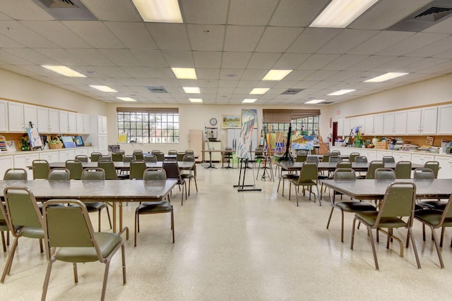 dining space with a drop ceiling