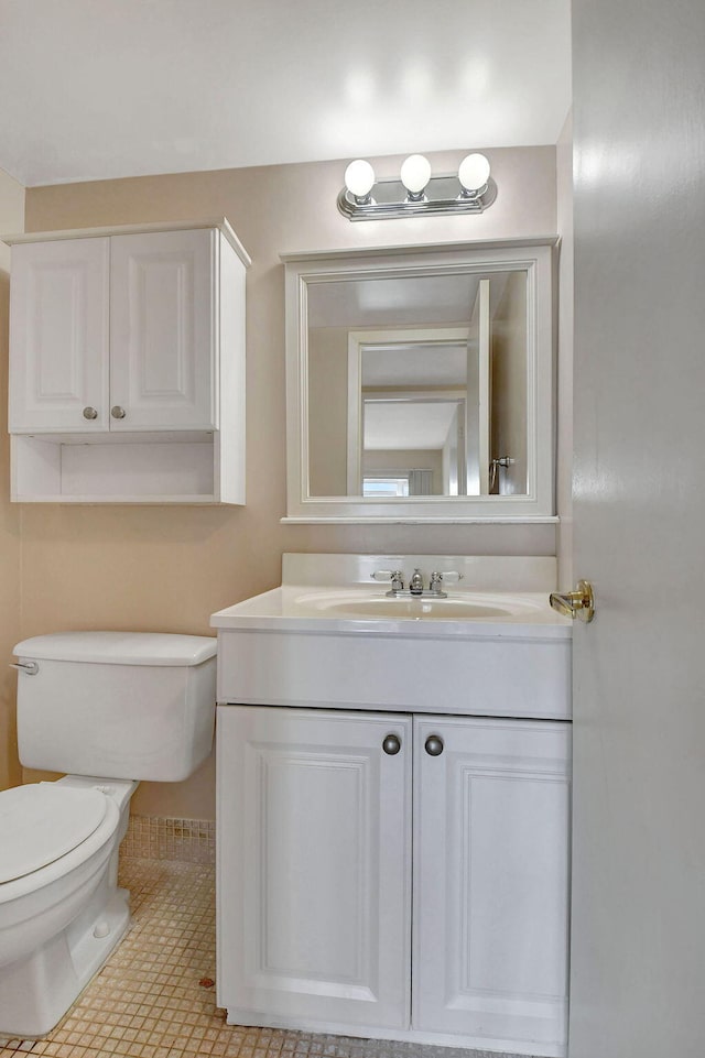 bathroom featuring vanity, toilet, and tile patterned floors