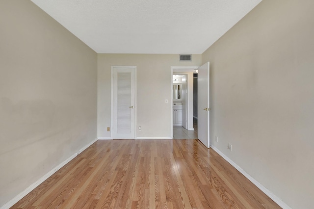 unfurnished bedroom with light wood-type flooring