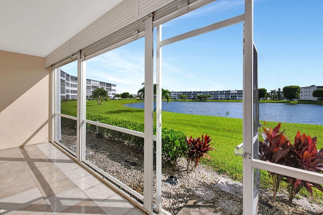 unfurnished sunroom featuring a water view