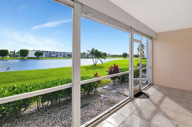 unfurnished sunroom featuring a water view