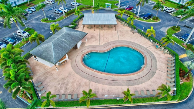 view of swimming pool featuring a patio and a hot tub