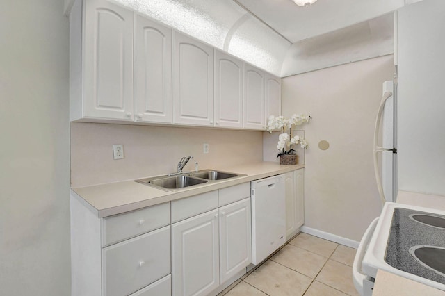 kitchen with white appliances, light tile patterned floors, sink, and white cabinets