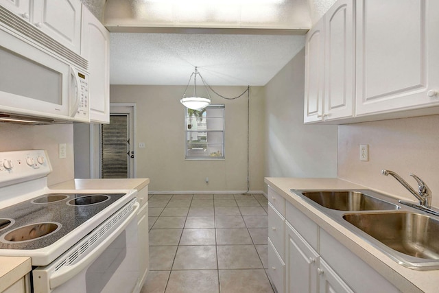 kitchen featuring sink, decorative light fixtures, light tile patterned floors, white cabinetry, and white appliances