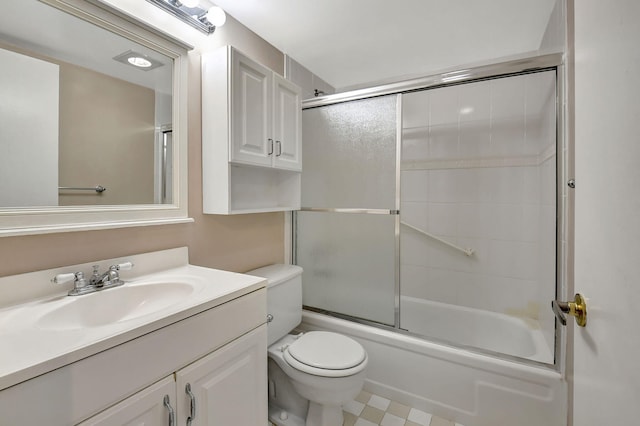 full bathroom featuring vanity, toilet, and shower / bath combination with glass door