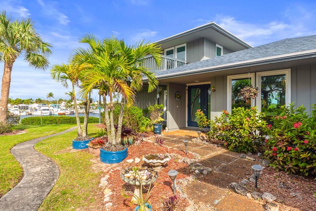 doorway to property with a yard