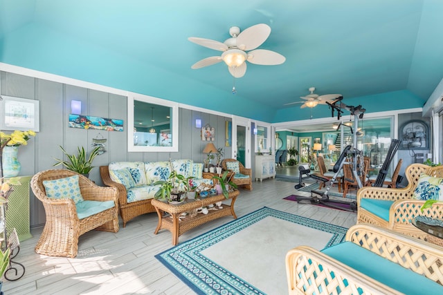 living room with lofted ceiling, ceiling fan, and light wood-type flooring