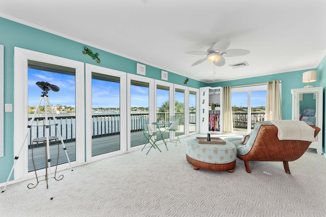 sitting room with ceiling fan and light colored carpet