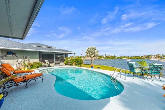 view of swimming pool featuring a patio area and a sunroom