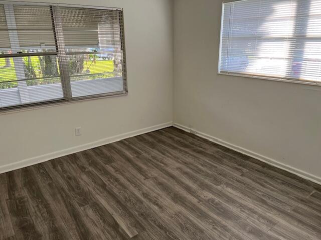 empty room with dark wood-type flooring