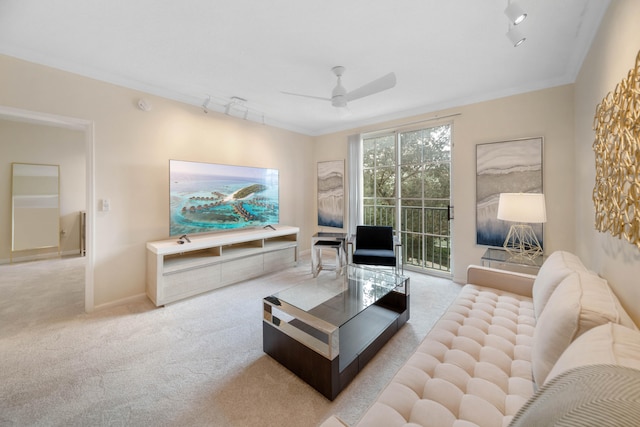 carpeted living room featuring ornamental molding, ceiling fan, and track lighting