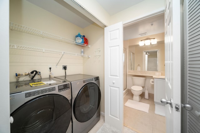 laundry room with light tile flooring, separate washer and dryer, hookup for an electric dryer, and washer hookup