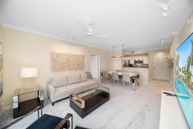 living room with track lighting, crown molding, and ceiling fan