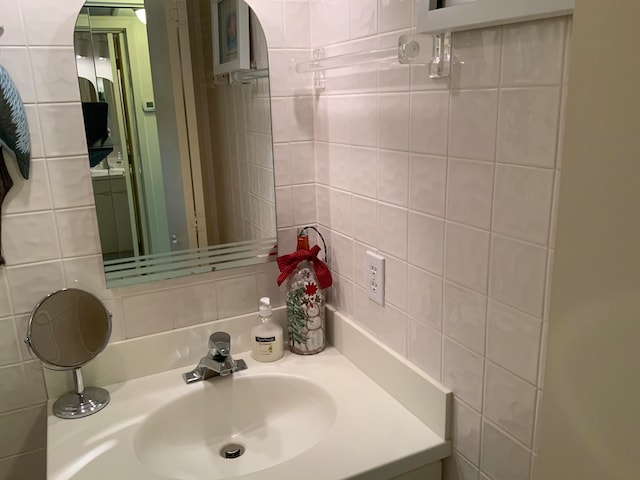 bathroom with tile walls and vanity