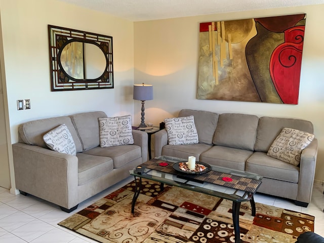 tiled living room featuring a textured ceiling