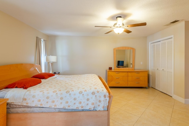 bedroom featuring a closet, ceiling fan, and light tile patterned flooring