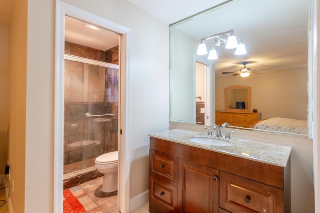 bathroom with a shower with door, vanity, ceiling fan, and toilet