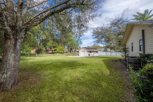 view of yard featuring an outbuilding and central AC unit