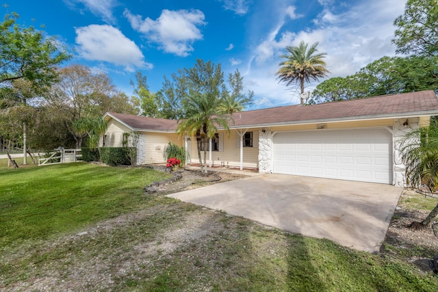 ranch-style home featuring a garage and a front lawn