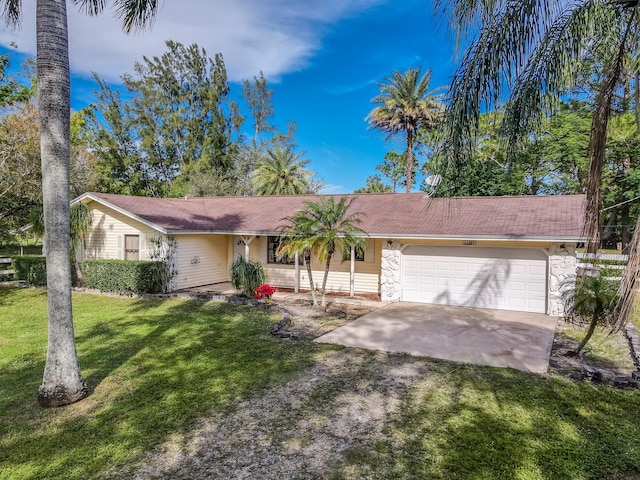 ranch-style home with a garage and a front yard