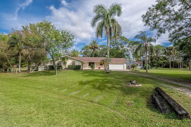 single story home featuring a garage and a front lawn