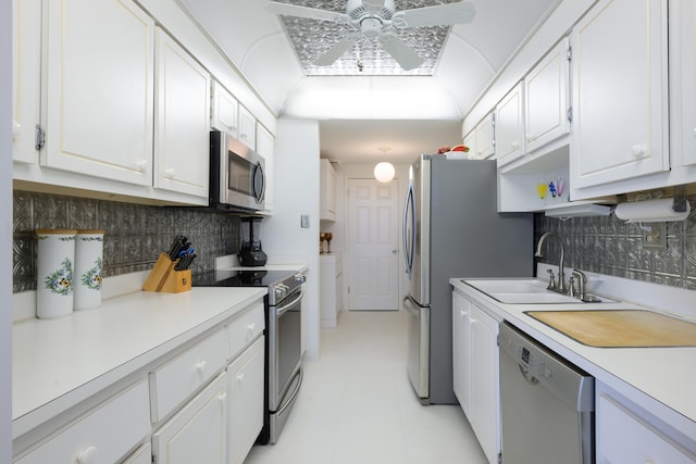 kitchen featuring tasteful backsplash, stainless steel appliances, ceiling fan, and white cabinets