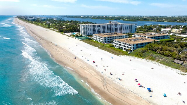 aerial view with a water view and a beach view