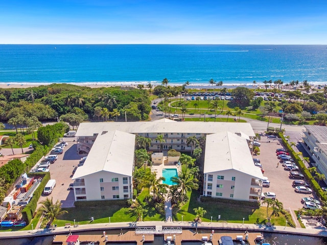 bird's eye view featuring a water view and a beach view