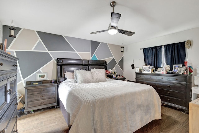 bedroom with hardwood / wood-style floors and ceiling fan