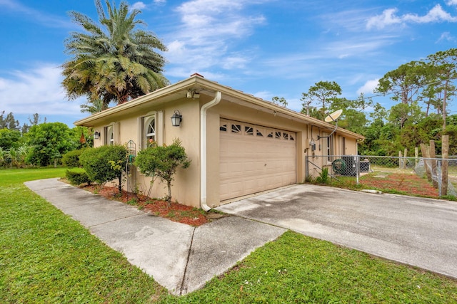 view of property exterior with a garage and a lawn