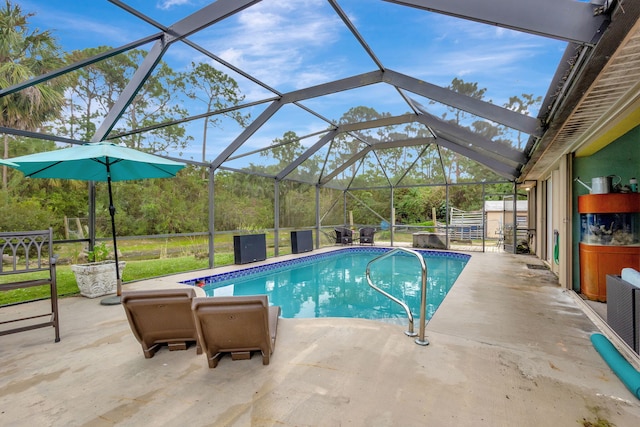 view of pool featuring glass enclosure and a patio area