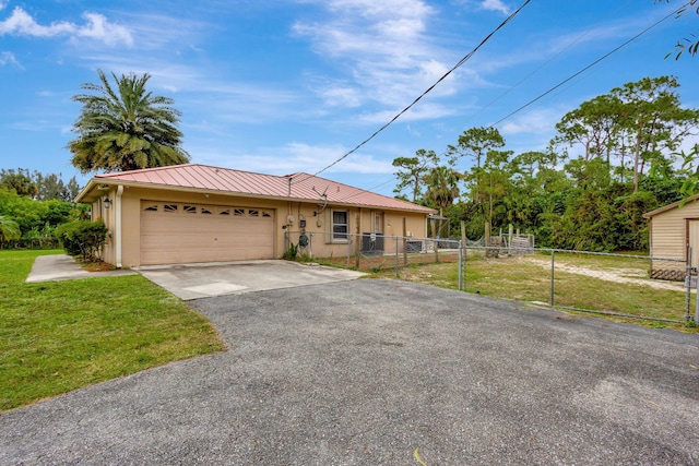 single story home with a garage and a front yard