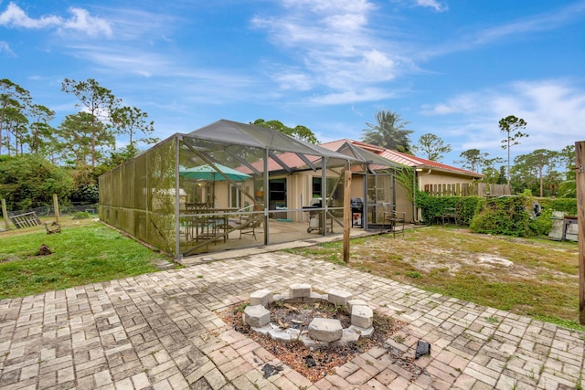 17891 N 86th St N, The Acreage, FL 33470 - rear view of house featuring a patio area, a fire pit, and glass enclosure