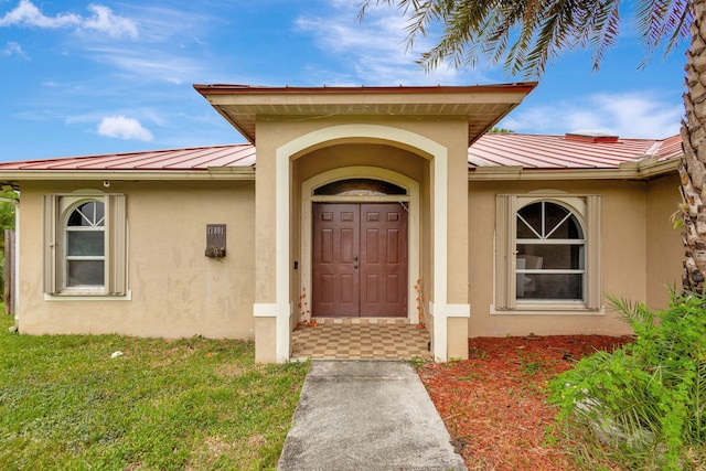 17891 N 86th St N, The Acreage, FL 33470 - property entrance with stucco siding, metal roof, a standing seam roof, and a lawn