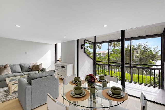 living room with expansive windows and light wood-type flooring