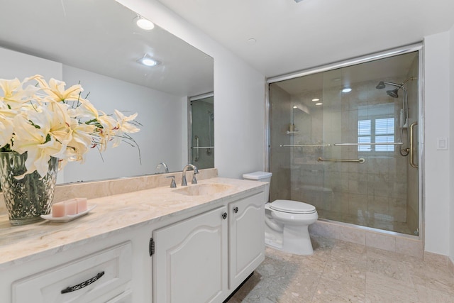 bathroom featuring toilet, tile floors, an enclosed shower, and vanity