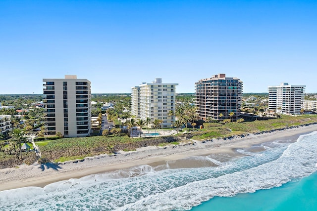 drone / aerial view featuring a water view and a view of the beach