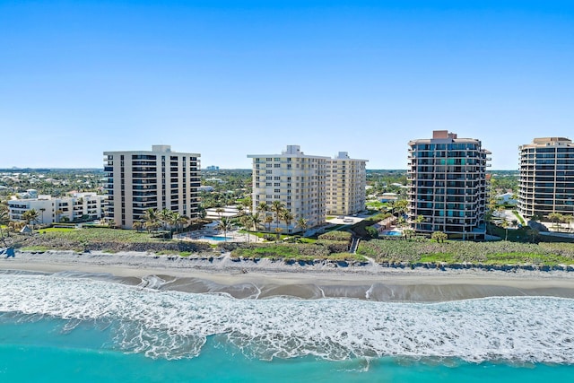 drone / aerial view with a water view and a view of the beach