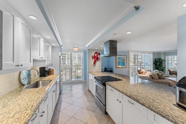 kitchen featuring white cabinetry, electric stove, a wealth of natural light, and island exhaust hood