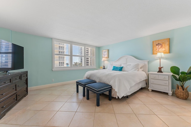 tiled bedroom featuring a textured ceiling