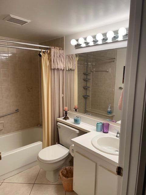 full bathroom featuring toilet, shower / tub combo with curtain, vanity, and tile patterned flooring