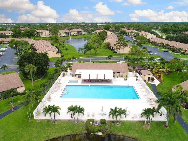 view of swimming pool featuring a water view and a patio area