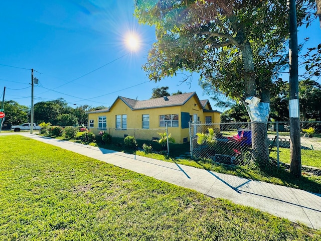 bungalow-style home with a front yard