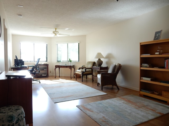 office with a textured ceiling, ceiling fan, and hardwood / wood-style flooring