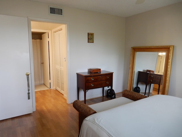 bedroom with a closet and light hardwood / wood-style flooring