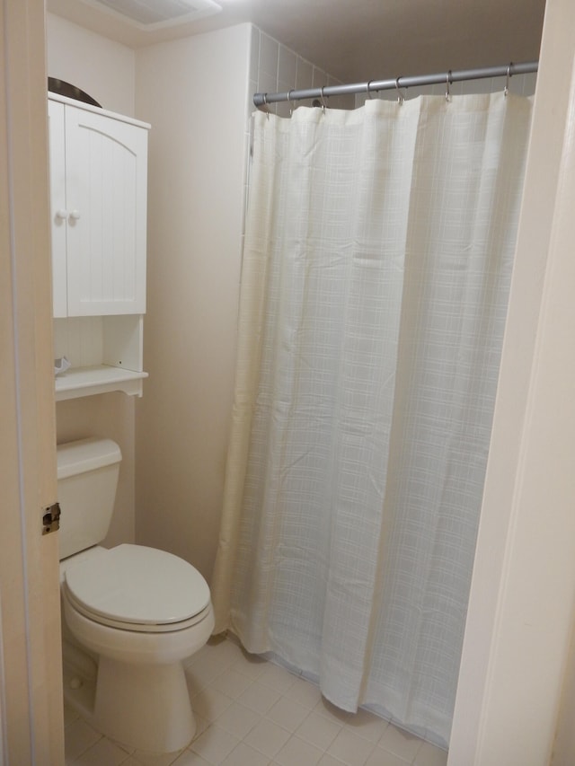 bathroom with toilet and tile flooring