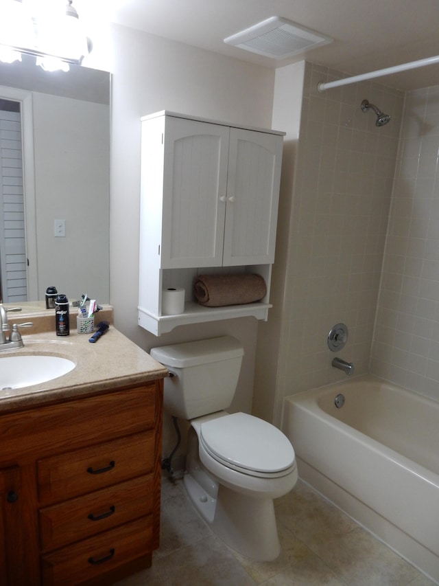 full bathroom featuring tiled shower / bath, toilet, tile floors, and large vanity